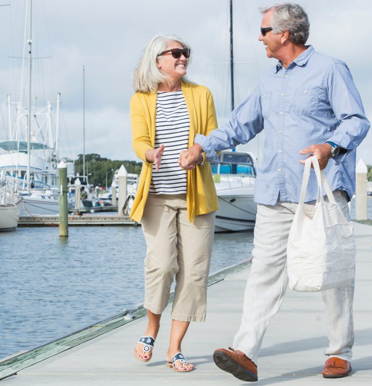 Senior citizens laughing on a dock