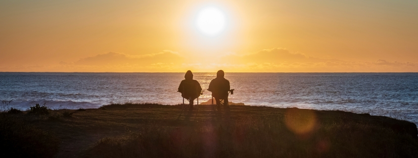 Old Couple Sits on beach