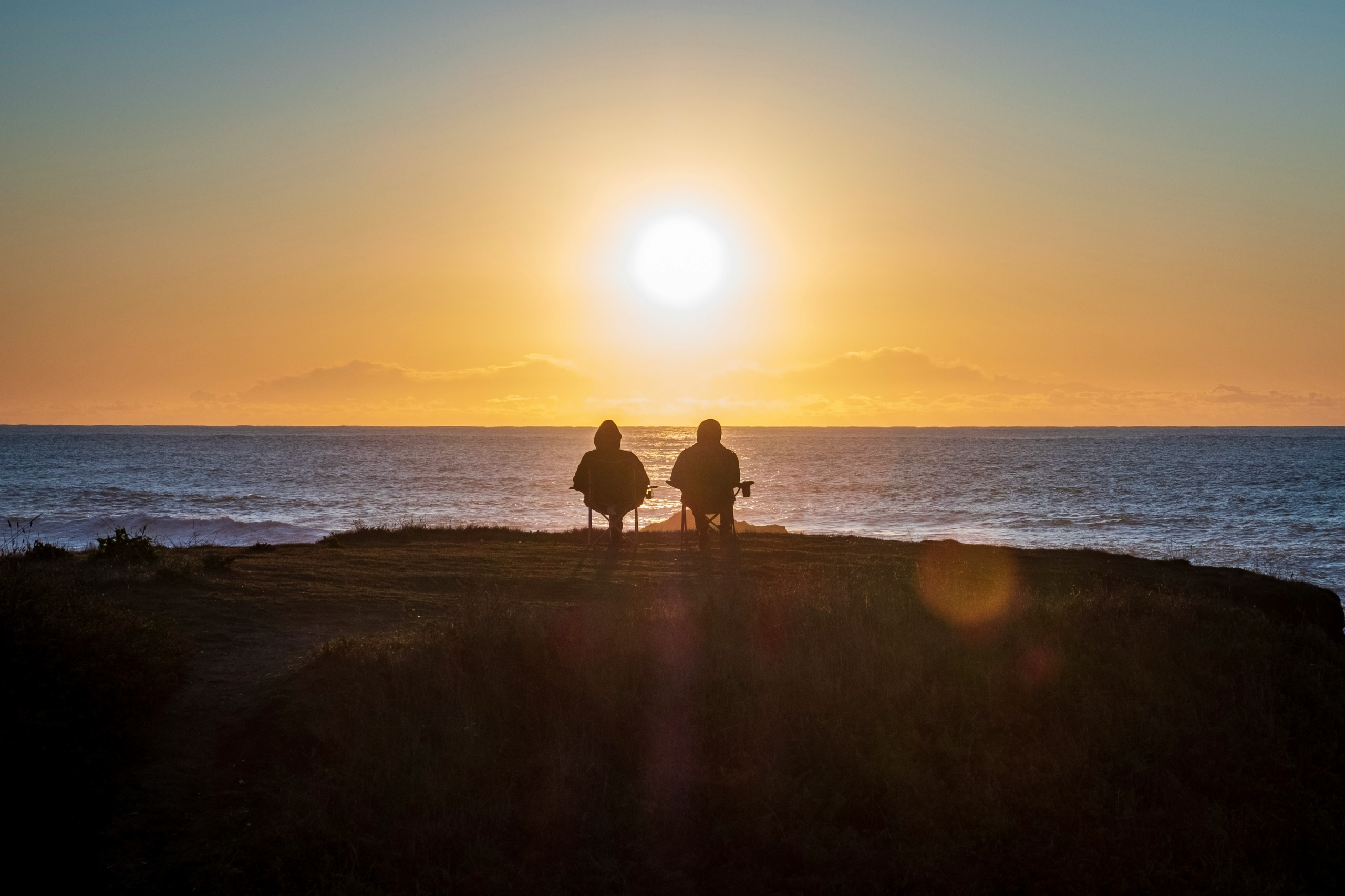 Old Couple Sits on beach