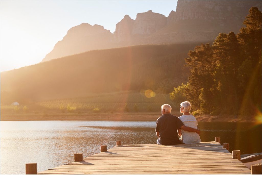 Senior citizens sitting at the end of a dock